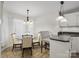 Cozy dining area featuring modern lighting fixtures and seating near kitchen at 132 General Pemberton St, Stanley, NC 28164