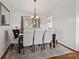 Elegant dining room featuring a modern chandelier, hardwood floors, and ample seating for entertaining guests at 132 General Pemberton St, Stanley, NC 28164