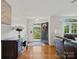 Inviting entryway with hardwood floors and an open door showcasing lush greenery at 132 General Pemberton St, Stanley, NC 28164