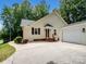Charming home exterior with a well-maintained lawn, driveway, and attached garage at 132 General Pemberton St, Stanley, NC 28164