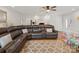 Comfortable living room with a large sectional sofa, ceiling fan, and hardwood flooring at 132 General Pemberton St, Stanley, NC 28164