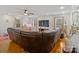 Bright living room with hardwood floors, ceiling fan, and a comfortable leather sofa at 132 General Pemberton St, Stanley, NC 28164
