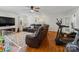 Spacious living room featuring hardwood floors, a large sectional, and a modern exercise machine at 132 General Pemberton St, Stanley, NC 28164