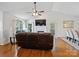 Inviting living room featuring hardwood floors, a fireplace, and large windows that flood the space with natural light at 132 General Pemberton St, Stanley, NC 28164