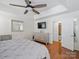 Bright main bedroom with a ceiling fan, hardwood floors, and modern decor at 132 General Pemberton St, Stanley, NC 28164