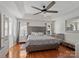 Serene main bedroom with tray ceilings, a ceiling fan, and a crib at 132 General Pemberton St, Stanley, NC 28164