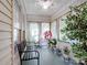 Cozy sunroom with natural light, bench seating, ceiling fan, and potted plants at 132 General Pemberton St, Stanley, NC 28164