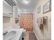 This is a compact bathroom with a sink, vanity, toilet, a shower curtain, and towel racks at 151 Robinson Rd, Gastonia, NC 28056