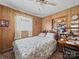 This bedroom offers a traditional-style ceiling fan, wood paneling, and a cozy atmosphere at 151 Robinson Rd, Gastonia, NC 28056