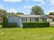 Charming single-story home with a well-manicured lawn and lush green shrubbery at 151 Robinson Rd, Gastonia, NC 28056