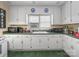 Bright kitchen featuring white cabinets, green counters, and essential appliances for cooking at 151 Robinson Rd, Gastonia, NC 28056