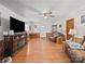 Cozy living room featuring hardwood floors, ceiling fan, fireplace, and comfortable leather seating at 151 Robinson Rd, Gastonia, NC 28056