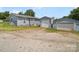 Rear exterior view showing the home, and detached garages at 151 Robinson Rd, Gastonia, NC 28056