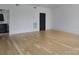 Light-filled bedroom featuring light wood flooring and an attached bathroom at 1511 Waverly Ave, Charlotte, NC 28203