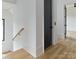 Bright hallway featuring hardwood floors, and modern staircase at 1511 Waverly Ave, Charlotte, NC 28203