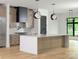 Sunlit kitchen showcasing island with bar seating, modern appliances, and sleek countertops at 1511 Waverly Ave, Charlotte, NC 28203