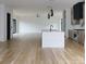 Open-concept kitchen with a large island, stainless appliances, and hardwood floors at 1511 Waverly Ave, Charlotte, NC 28203