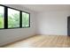 Spacious living room with light hardwood floors and large windows with great views at 1511 Waverly Ave, Charlotte, NC 28203