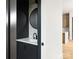 Stylish powder room with a modern vanity, round mirror and sleek black fixtures at 1511 Waverly Ave, Charlotte, NC 28203