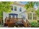 Home's backyard featuring a deck, grill, and patio umbrella; perfect for outdoor relaxation at 15620 Glen Miro Dr, Huntersville, NC 28078