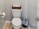 Powder room with modern toilet, grey paint, and basket storage on top at 15620 Glen Miro Dr, Huntersville, NC 28078