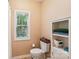 Bathroom with storage next to toilet and bright window that lets in sunlight at 15620 Glen Miro Dr, Huntersville, NC 28078