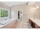 Bright bathroom featuring a soaking tub with tile surround, walk-in closet, and vanity at 15620 Glen Miro Dr, Huntersville, NC 28078