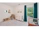 Cozy bedroom with comfortable chair, neutral tones, and a large window at 15620 Glen Miro Dr, Huntersville, NC 28078