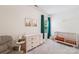 Cozy bedroom with comfortable chair, neutral tones, and a large window at 15620 Glen Miro Dr, Huntersville, NC 28078
