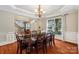 Elegant dining room features hardwood floors, decorative molding, and a classic chandelier at 15620 Glen Miro Dr, Huntersville, NC 28078