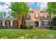Classic brick home with a well-manicured lawn and mature tree in a desirable neighborhood at 15620 Glen Miro Dr, Huntersville, NC 28078