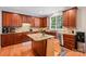 Well-appointed kitchen features wooden cabinetry, granite countertops, and stainless steel appliances at 15620 Glen Miro Dr, Huntersville, NC 28078
