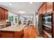 Open kitchen with stainless steel appliances and granite island, connected to the living area at 15620 Glen Miro Dr, Huntersville, NC 28078