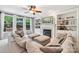 Bright living room with fireplace, built-in bookshelves, and large windows offering natural light at 15620 Glen Miro Dr, Huntersville, NC 28078