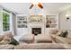 Comfortable living room with a fireplace, flanked by custom built-in shelving at 15620 Glen Miro Dr, Huntersville, NC 28078