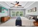 Bright main bedroom features tray ceilings, large windows, and stylish decor at 15620 Glen Miro Dr, Huntersville, NC 28078