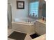 Bright bathroom featuring a garden tub and double vanity at 1713 Arbor Way, Albemarle, NC 28001