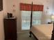 Bedroom features a four-poster bed and natural light at 1713 Arbor Way, Albemarle, NC 28001