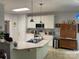 Bright kitchen with white cabinets, modern appliances, and a functional island at 1713 Arbor Way, Albemarle, NC 28001