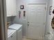 Laundry room features a washer, dryer, storage cabinets, and easy access to the outdoors at 1713 Arbor Way, Albemarle, NC 28001