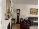 Living room featuring fireplace, hardwood floors, a grandfather clock, and comfortable leather seating at 1713 Arbor Way, Albemarle, NC 28001