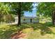 Backyard of home featuring green grass, trees, and a chain link fence at 203 Nottingham Dr, York, SC 29745