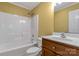 This bathroom features a shower-tub combination, white tile, and a wood-look vanity with a sink at 203 Nottingham Dr, York, SC 29745