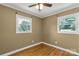Bedroom featuring two windows, ceiling fan, and hardwood floors at 203 Nottingham Dr, York, SC 29745