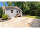 View of gray brick home featuring a fenced yard and wooden stairs leading to the back door at 203 Nottingham Dr, York, SC 29745