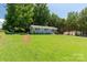 Charming one-story home with light blue brick and a large front yard under a blue sky at 203 Nottingham Dr, York, SC 29745