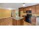 Well-lit kitchen with wooden cabinets, granite countertops and modern appliances at 203 Nottingham Dr, York, SC 29745