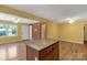 Kitchen island with granite countertops, hardwood flooring, and white trim at 203 Nottingham Dr, York, SC 29745