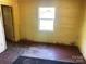 A bright bedroom featuring a window, worn wood floors, and a glimpse into an adjacent room at 213 Maple St, Rock Hill, SC 29730