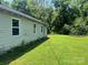 Lawn view of home with vinyl siding, updated windows, and mature trees at 213 Maple St, Rock Hill, SC 29730